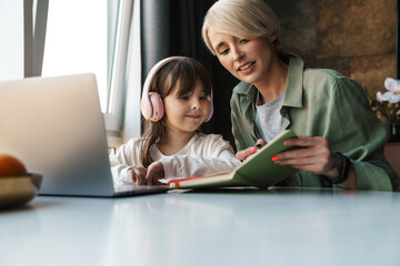 Canvas Print - Mother helping her daughter with her homework