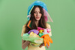 © Drobot Dean - Young brunette woman with plastic waste expressing surprise at camera