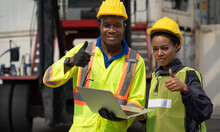 Black African Male And Female Worker Showing Thumbs Up With Laptop Working At Warehouse Container Cargo Ship Import Export Industry