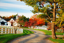 A Country Lanes Winds Through Beautiful Autumn Foliage 