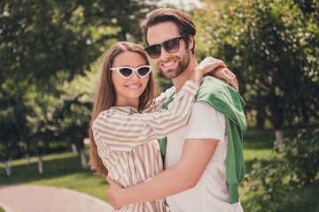 Sticker - Photo portriat young couple smiling cuddling together having romantic date in green park