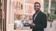 © arrowsmith2 - African businessman in suits use mobile phones happily in the city.Business and technology concept