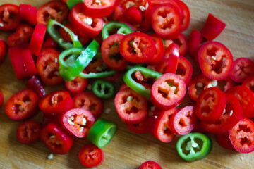 Poster - Closeup of red and green chili peppers on a wooden table