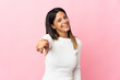 © luismolinero - Caucasian girl isolated on pink background pointing front with happy expression