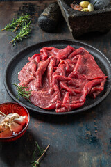 Wall Mural - Beef tenderloin with herbs and spices on cast iron plate