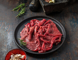 Wall Mural - Beef tenderloin with herbs and spices on cast iron plate