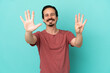 © luismolinero - Young caucasian man isolated on blue background counting nine with fingers