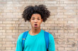 © Viviland - Afro latin male teenager doing a strange face against a wall