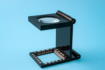 Poster - Quality control and printing industry inspection tools concept with linen test magnifier lens tool isolated on blue background