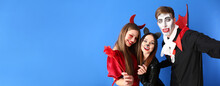 Friends In Halloween Costumes Taking Selfie On Color Background With Space For Text