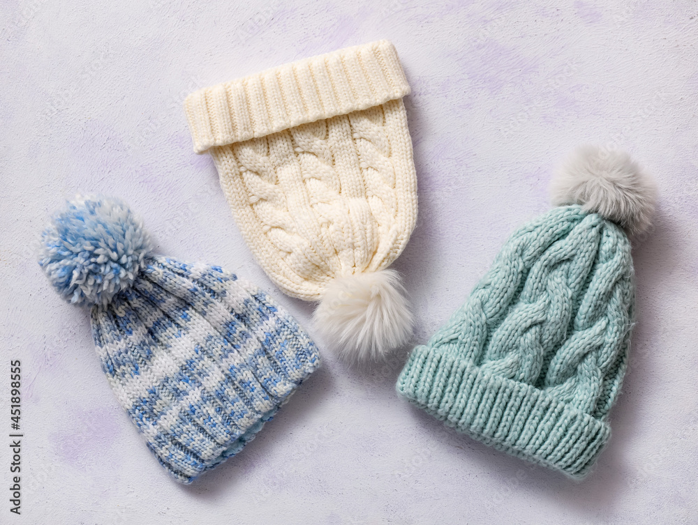 Different warm hats on color background