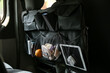 Travel organizer with different things on car seat, closeup