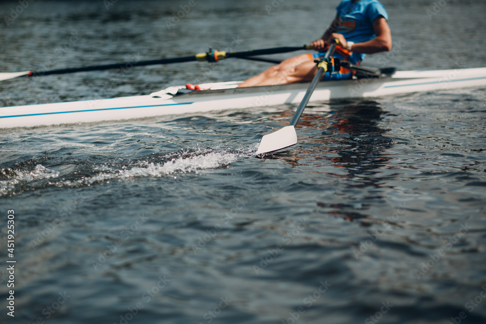 Sportsman single scull man rower rowing on boat. Oar paddle water splash movement - obrazy, fototapety, plakaty 
