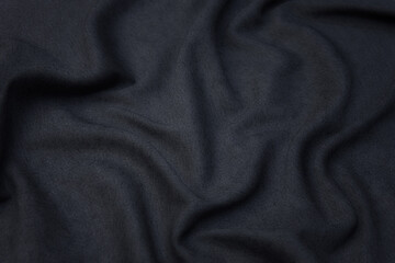 Close-up texture of natural gray fabric or cloth in gray color. Fabric texture of natural cotton or linen textile material. Gray canvas background.