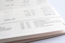 Inside Page Of A Bank Savings Account Passbook Showing The Debit And Credit Amount And Current Balance. A Banking Account Statement Book Printed With The Account Transaction History. Closeup View.