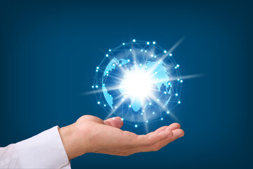Poster - Human hand holding earth globe on blue  background, Global networking connection and data exchanges, global communication network concept