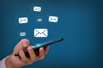 Poster - Hand using smartphone with sending email on blue background