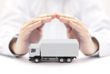 Canvas Print - White cargo delivery truck protected by hands