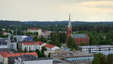Fototapeta Miasto - Panorama of the city of Mikkeli in Finland before the rain in summer: roofs of houses horizon forest lutheran church.