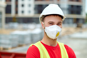 Poster - Construction worker in a safety helmet posing for the camera