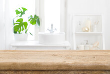 Empty Wooden Table Top With Blurred Bathroom Sink Interior Background