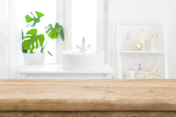 Wall Mural - empty wooden table top with blurred bathroom sink interior background