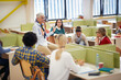 © luckybusiness - Female professor attracts students attention at a lecture