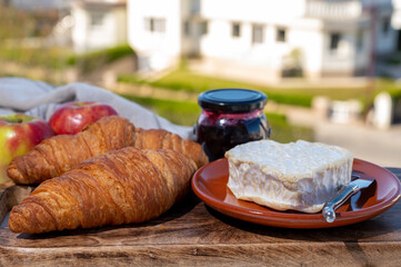 French breakfast with fresh baked croissants and cheeses from Normandy, camembert and neufchatel served outdoor with nice city view