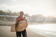 © Alessandro Biascioli - Senior male having fun surfing during sunset time - Fit retired man training with surfboard on the beach - Elderly healthy people lifestyle and extreme sport concept
