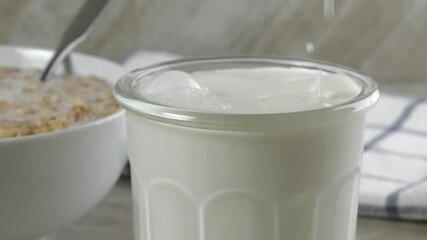 Poster - Pouring milk into a glass next to a bowl of breakfast cereal