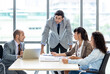 © Pornsak - Businesspeople discussing together in the conference room during meeting at the office.