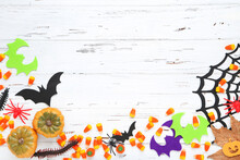Halloween Pumpkins, Candies, Colorful Bats, Spiderweb And Spiders On Wooden Background