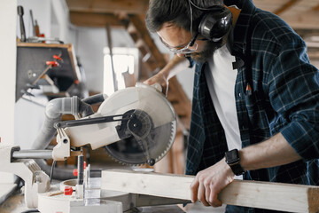 Wall Mural - Carpenter working with circular saw