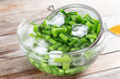 Green beans in a colander. Boiled or blanched vegetables on a table