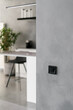 © brizmaker - Black light switch on grey kitchen wall