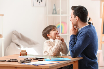 Sticker - Speech therapist working with little boy in office