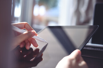 Poster - Woman using stylus pen on digital tablet computer, close up