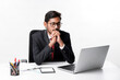 © PRASANNAPIX - Young indian man in suit and working on laptop at office
