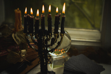 Candle burns on the altar, magic among candles, clean energy, magical concept, autumn time