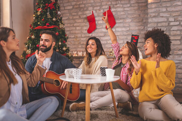 Wall Mural - Friends celebrating Christmas together