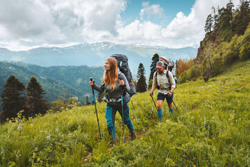 Wall Mural - family hiking in mountains travel adventure vacations group hikers couple with baby trekking outdoor