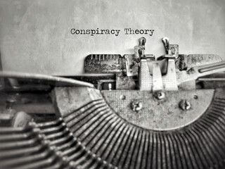 Social Issues Concept - Conspiracy Theory text in vintage background. Stock photo.