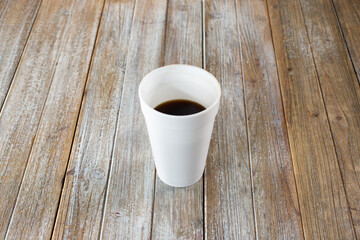 Wall Mural - A view of a black coffee inside a white styrofoam cup.