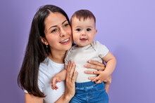 Woman Mother In Light Clothes Have Fun With Cute Child Baby Girl, Isolated On Pastel Purple Wall Background Studio Portrait Mother's Day Love Family Parenthood Childhood Concept. Copy Space