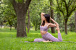 © Edgar1 BJ - Latin woman doing Yoga-asanas with different postures, in the outdoor park with grass and trees in the background