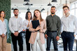 © alfa27 - Portrait Of Young Caucasian Business Team In The Head Of Beautiful Lady Posing At Camera, Looking Nice And Affable. Confident Managers And Leaders In Bright Modern Office, At Business Meeting
