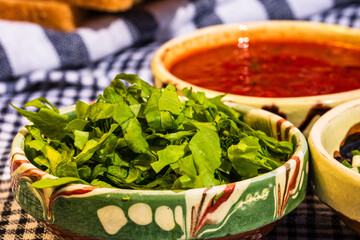 Wall Mural - Selective shot of spinach salad and tomato sauce for a healthy breakfast