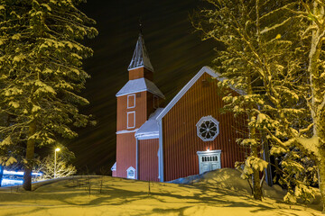northern norway. church covered in snow. long exposure night photo with diffracted light and motion 