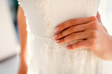 Wall Mural - Young attractive bride in white beautiful wedding dress posing at the room. Wedding concept. Cropped view