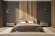 Dark bedroom interior with large bed, bedsides, carpet and pillows